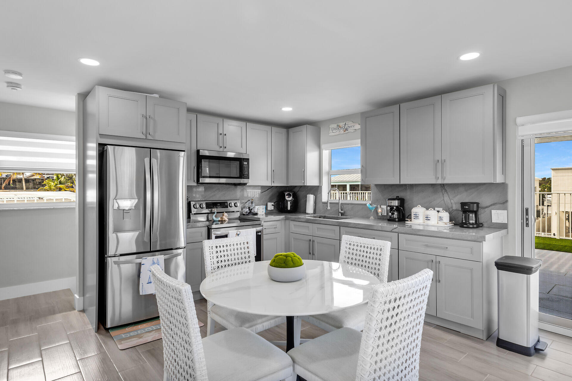 1007 Hialeah Lane Key Largo, FL 33037 - Photo 22 of 41 a kitchen with a refrigerator a stove a sink a dining table and chairs