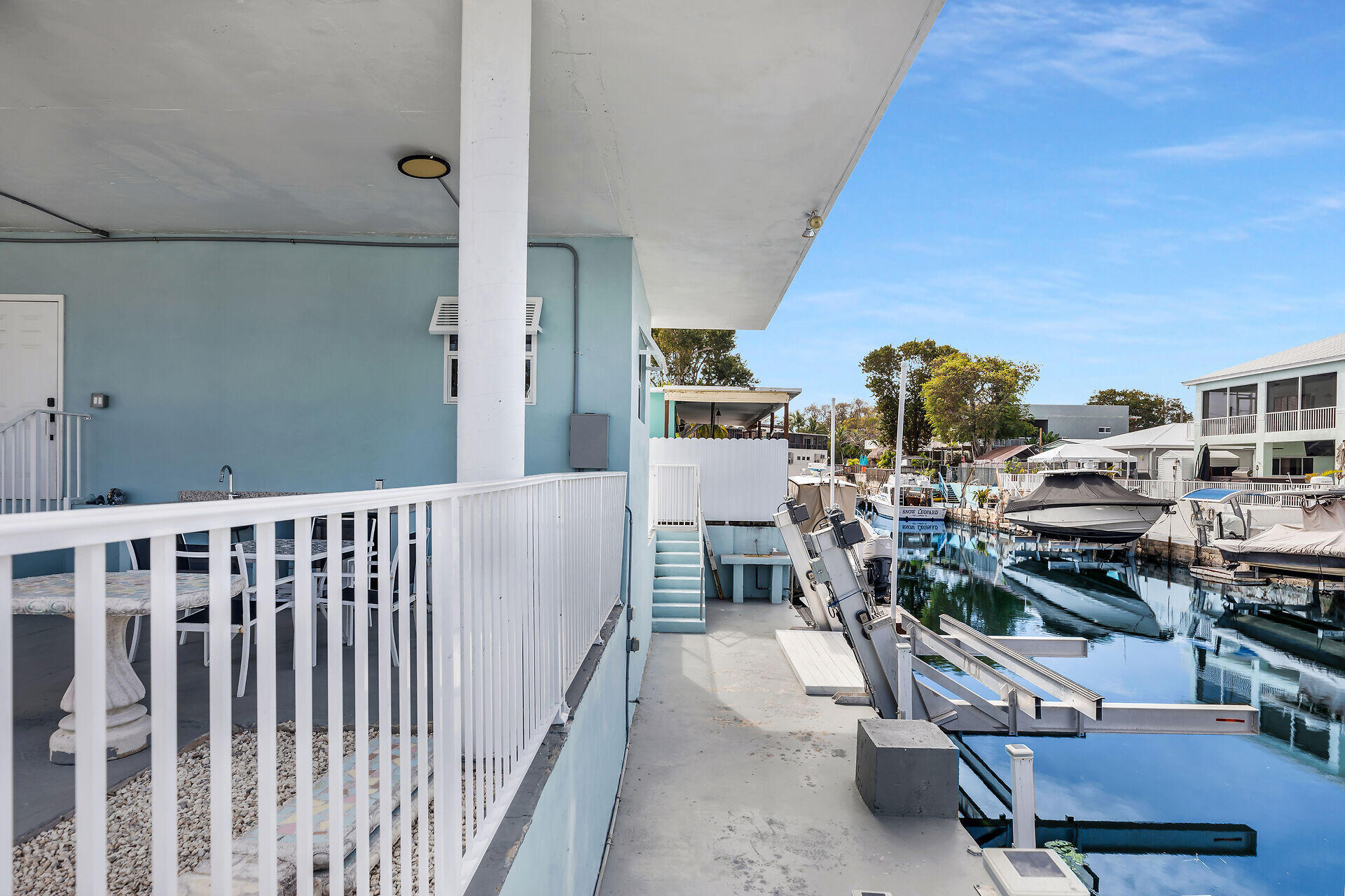 1007 Hialeah Lane Key Largo, FL 33037 - Photo 33 of 41 a living room with furniture a stove and a wooden floor