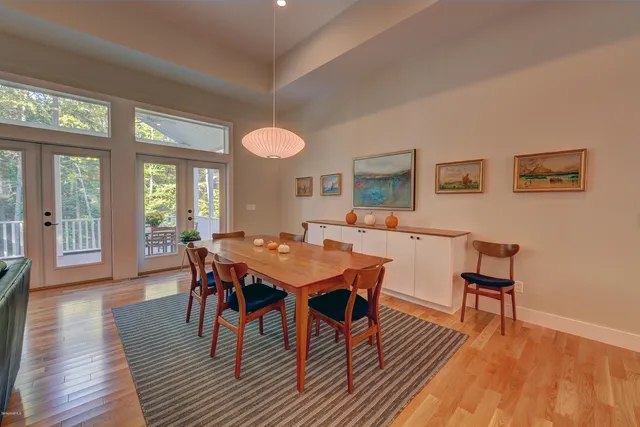 a living room with furniture lamps and wooden floor
