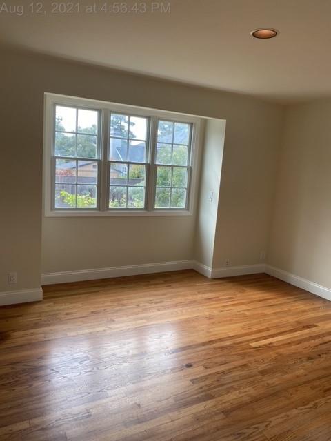 3084 Larkin Road Pebble Beach, CA 93953 - Photo 6 of 16 a view of an empty room with wooden floor and a window