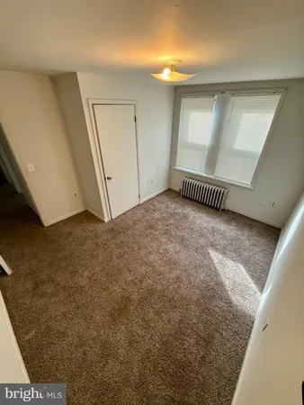 a view of a livingroom with an empty space and wooden floor