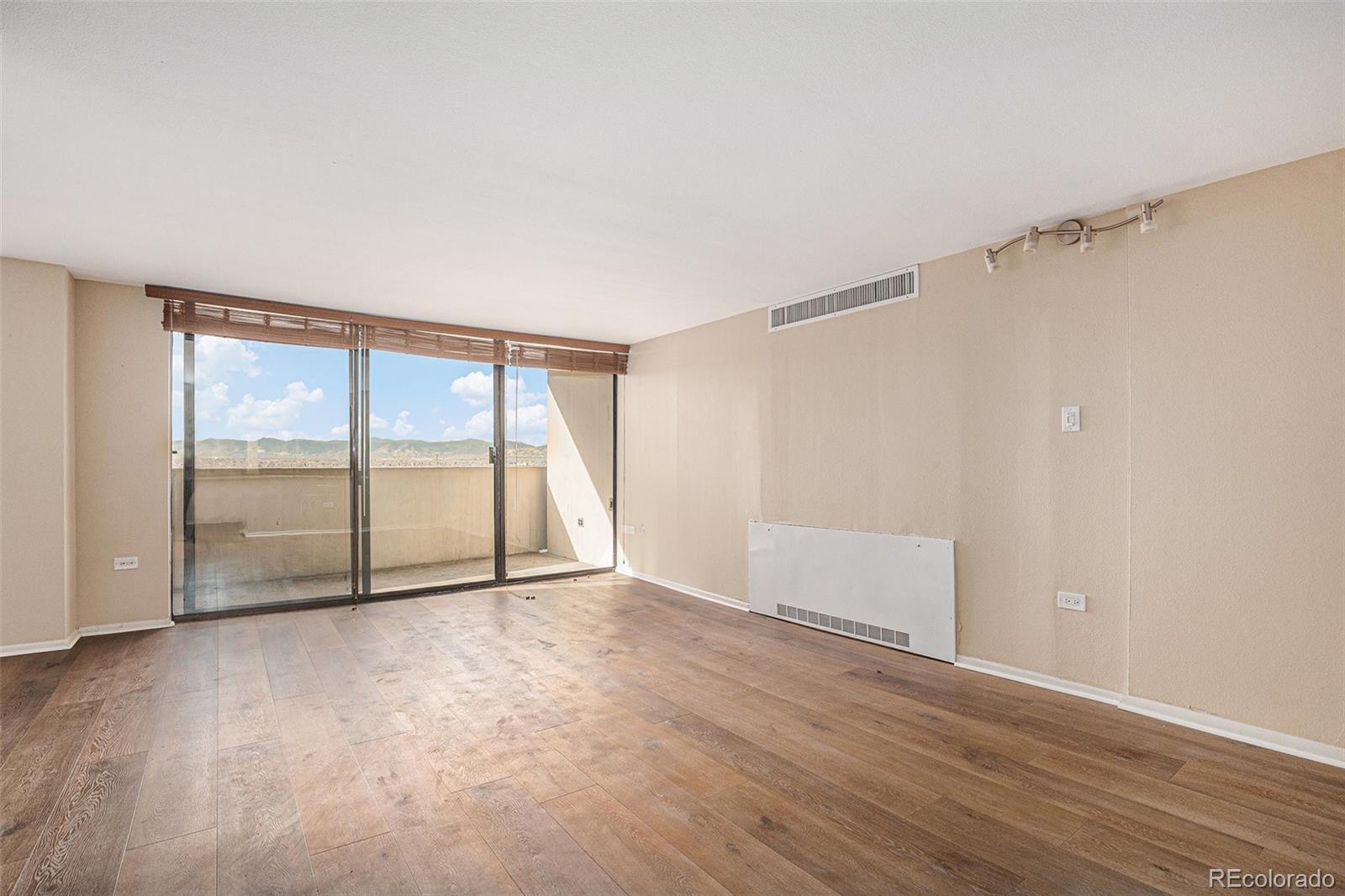 1020 15th Street, Unit 20N Denver, CO 80202 - Photo 2 of 10 a view of an empty room with wooden floor and a window
