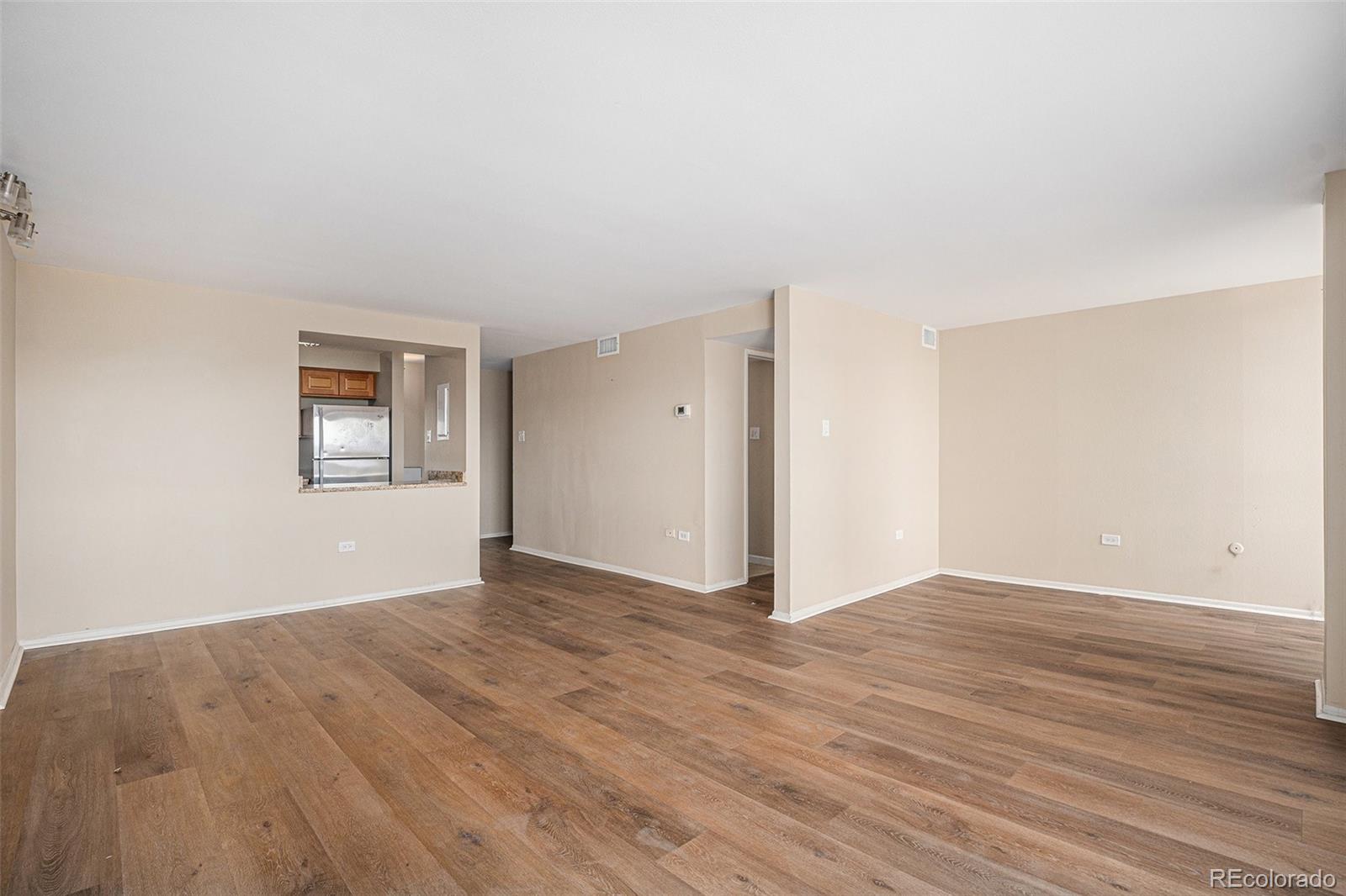 1020 15th Street, Unit 20N Denver, CO 80202 - Photo 3 of 10 a view of an empty room with wooden floor and a window