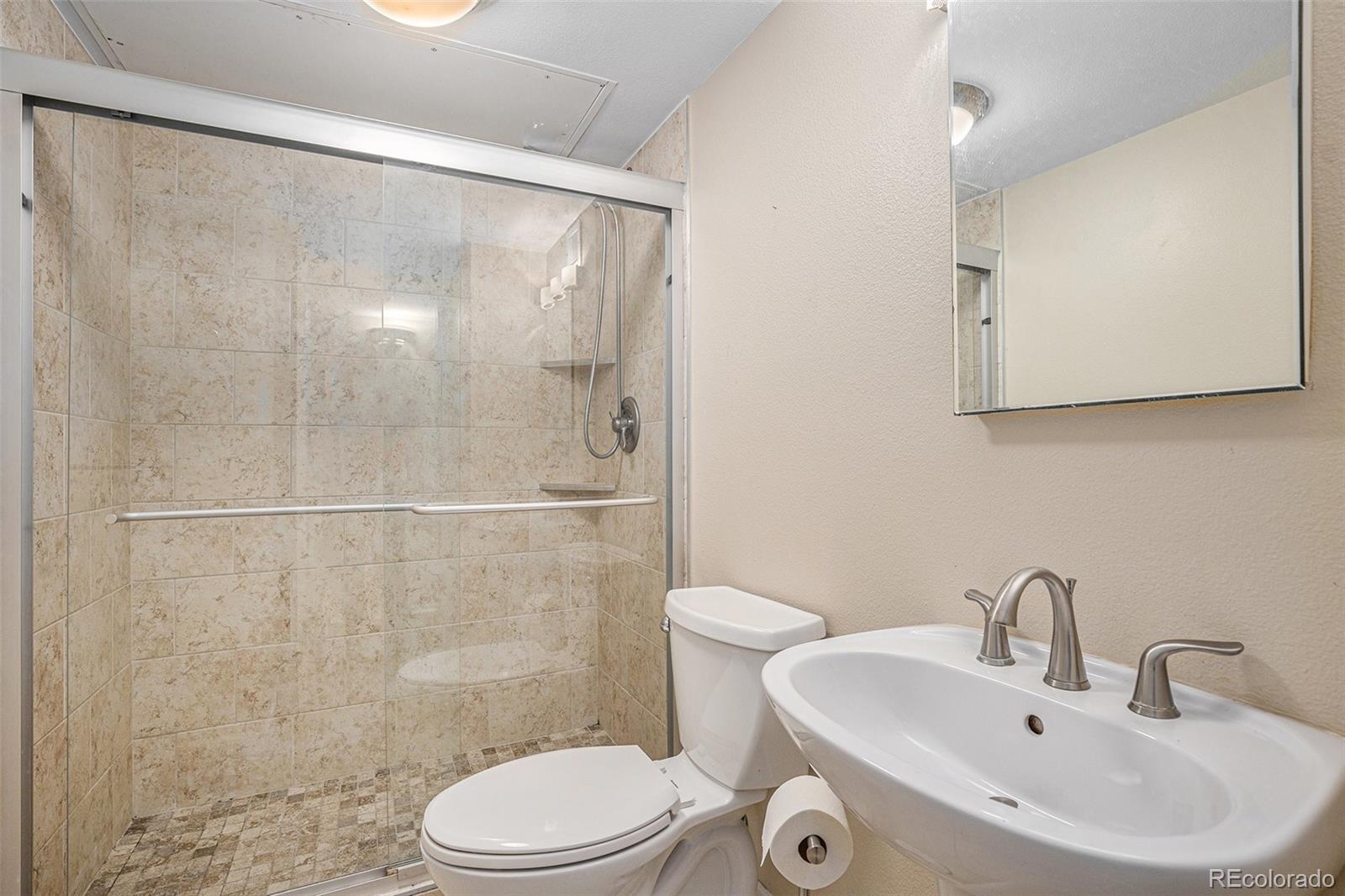 1020 15th Street, Unit 20N Denver, CO 80202 - Photo 8 of 10 a bathroom with a sink a toilet and shower