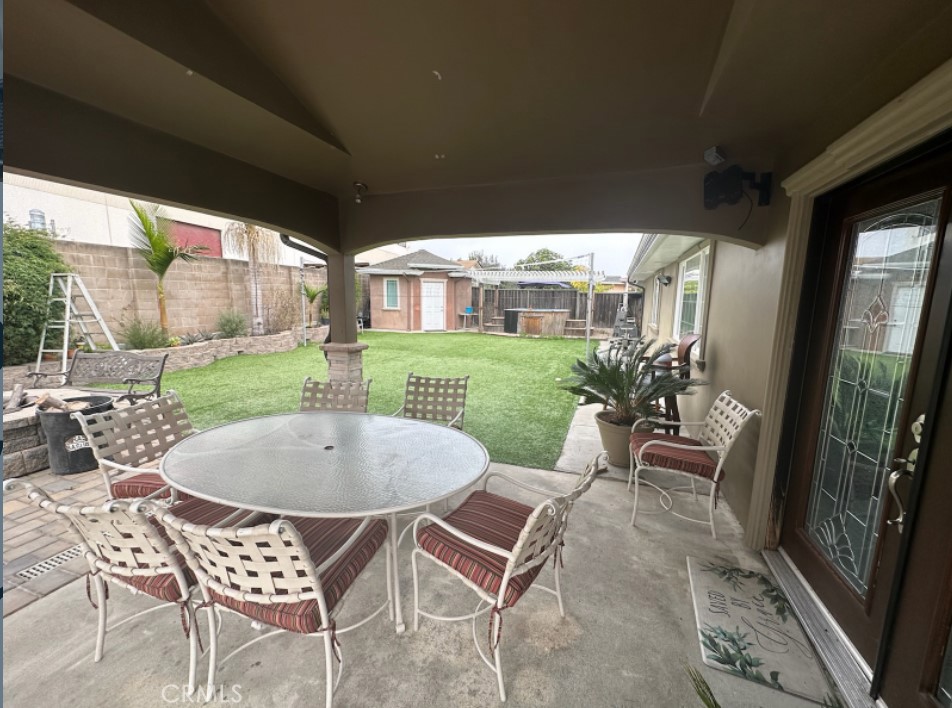 48 Jeanette Way Watsonville, CA 95076 - Photo 13 of 14 a view of a patio with table and chairs potted plants and floor to ceiling window
