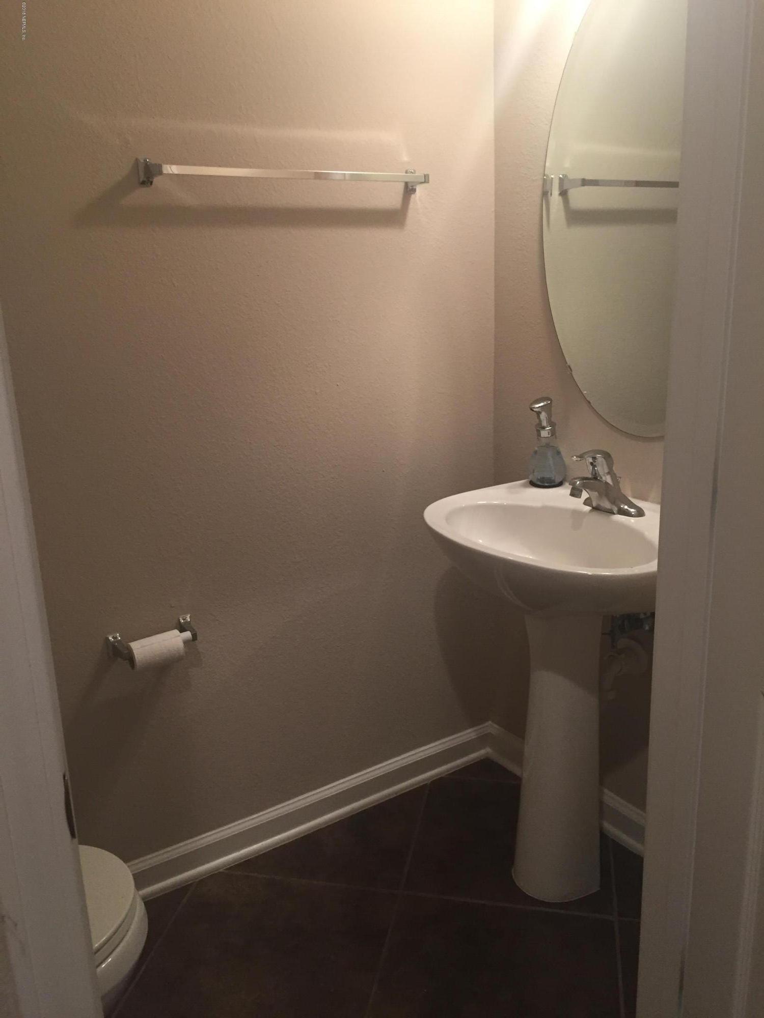 12978 Spring Rain Road Jacksonville, FL 32258 - Photo 2 of 17 a bathroom with a sink a toilet and a mirror