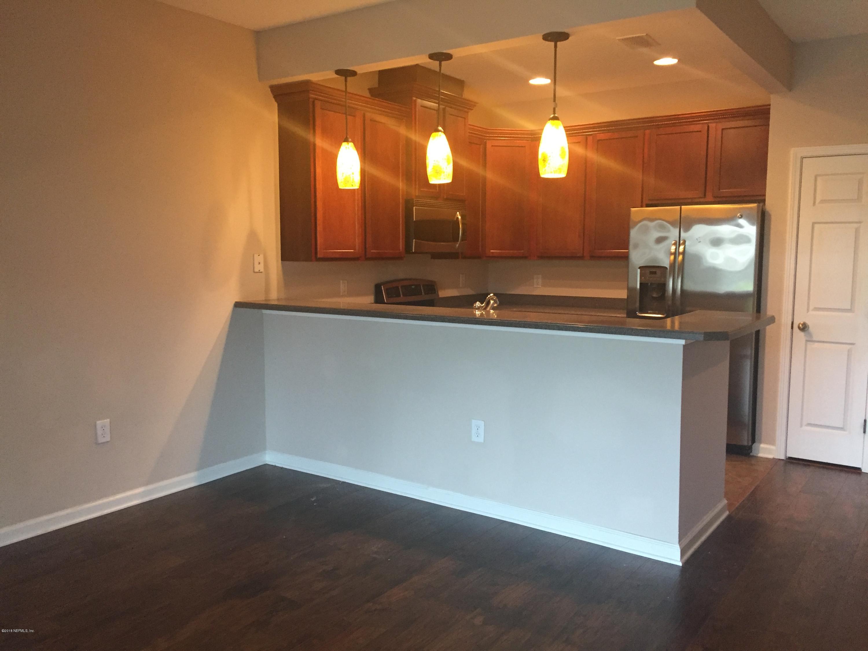 12978 Spring Rain Road Jacksonville, FL 32258 - Photo 5 of 17 a view of a large room with a large mirror and sink