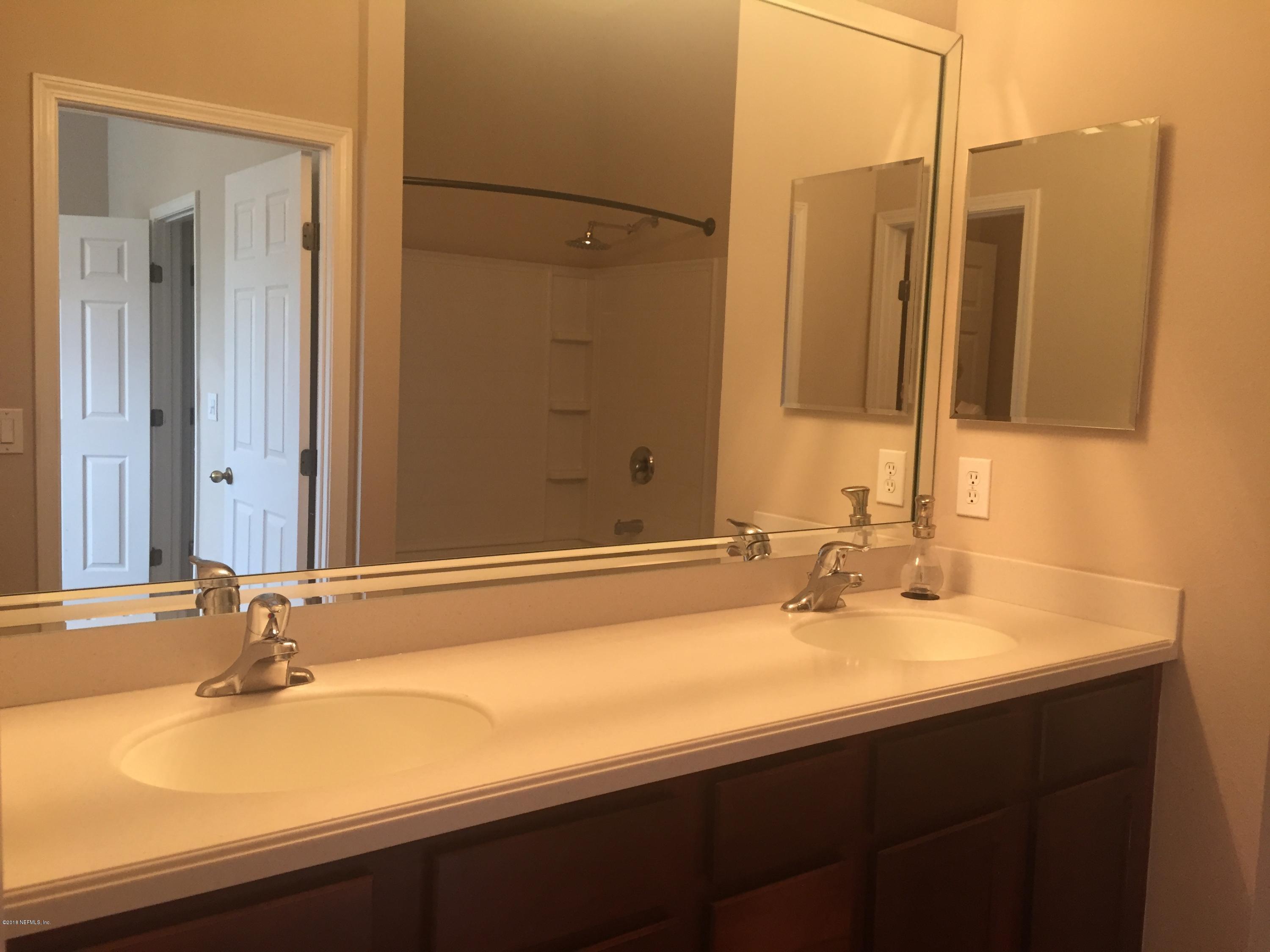 12978 Spring Rain Road Jacksonville, FL 32258 - Photo 8 of 17 a bathroom with a sink and a mirror