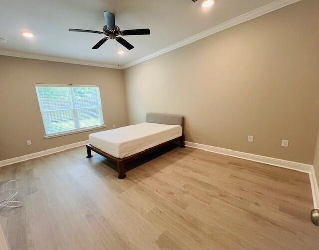 201 Lightning Bug Lane, Unit LOT 58 Freeport, FL 32439 - Photo 16 of 40 a spacious bedroom with a bed and window