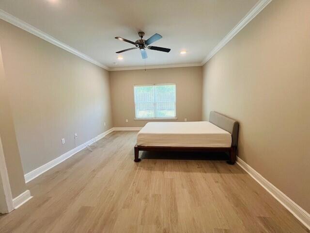 201 Lightning Bug Lane, Unit LOT 58 Freeport, FL 32439 - Photo 17 of 40 a spacious bedroom with a bed and a ceiling fan