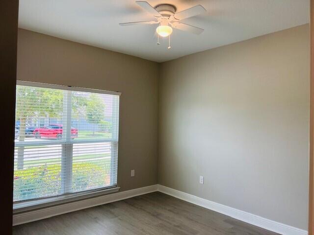 201 Lightning Bug Lane, Unit LOT 58 Freeport, FL 32439 - Photo 23 of 40 an empty room with wooden floor fan and windows