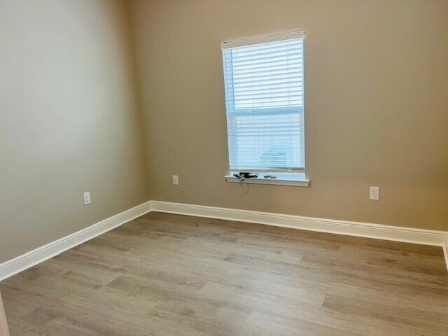 201 Lightning Bug Lane, Unit LOT 58 Freeport, FL 32439 - Photo 25 of 40 an empty room with wooden floor and windows