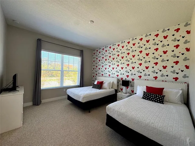 a bedroom with two beds and a window