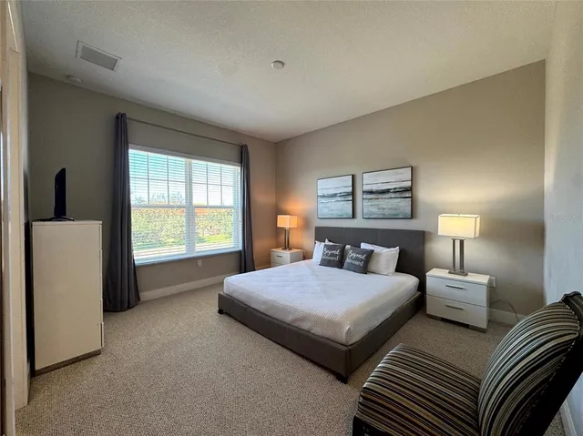 a bedroom with two beds and a window