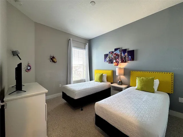 a bedroom with two beds and a window