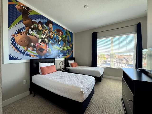 a bedroom with furniture and a large window