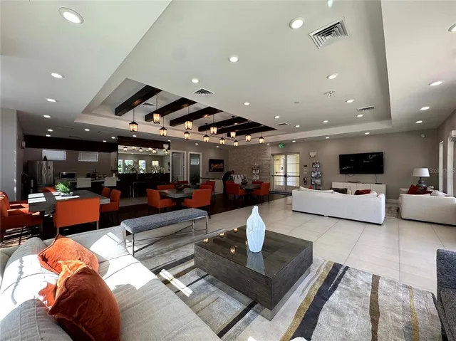 a living room with furniture and a chandelier