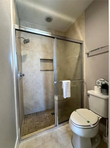 a bathroom with a toilet and a shower