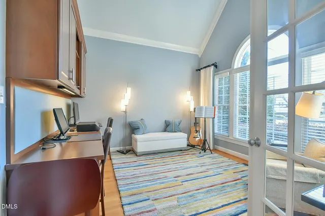 a view of a workspace with furniture and a window