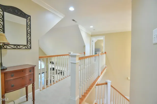 a bedroom with a white bed and ceiling fan