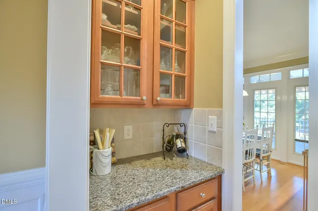 a kitchen with a granite countertop sink and cabinets