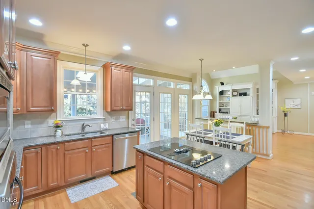 a kitchen with granite countertop a sink stove and cabinets