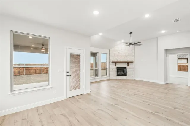 a bathroom with a tub a sink double vanity and mirror