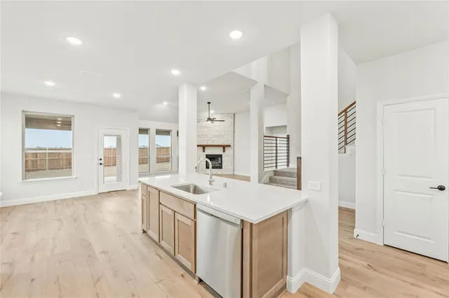 an entryway in a hall with a window and wooden floor