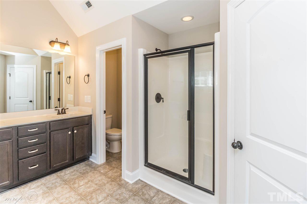 3508 Bloomfield Way Raleigh, NC 27616 - Photo 14 of 24 a spacious bathroom with a shower sink and mirror