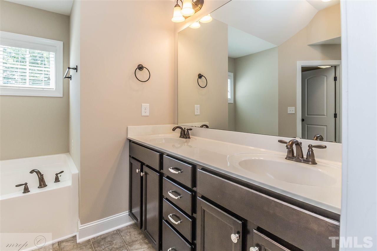 3508 Bloomfield Way Raleigh, NC 27616 - Photo 15 of 24 a bathroom with a sink double vanity and a bathtub