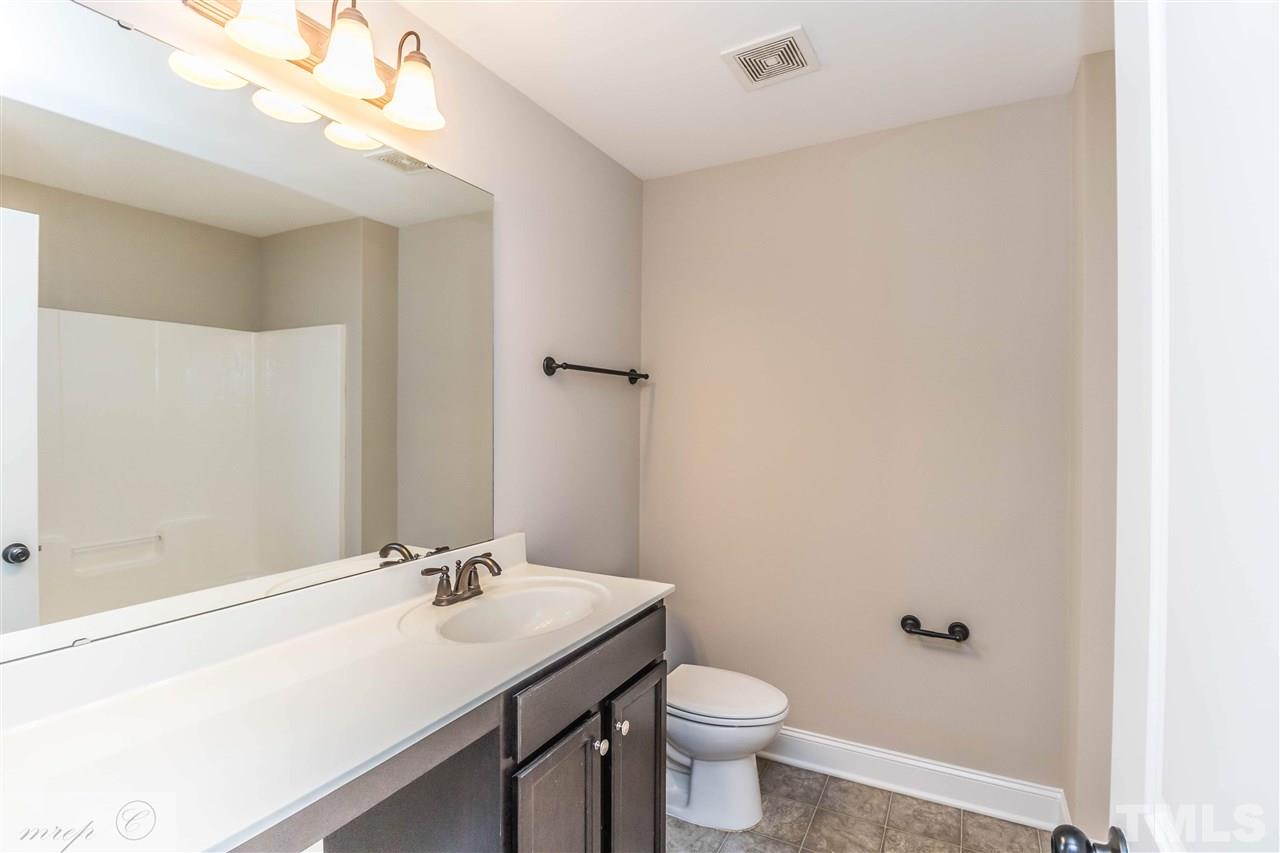 3508 Bloomfield Way Raleigh, NC 27616 - Photo 20 of 24 a bathroom with a sink a toilet and a mirror