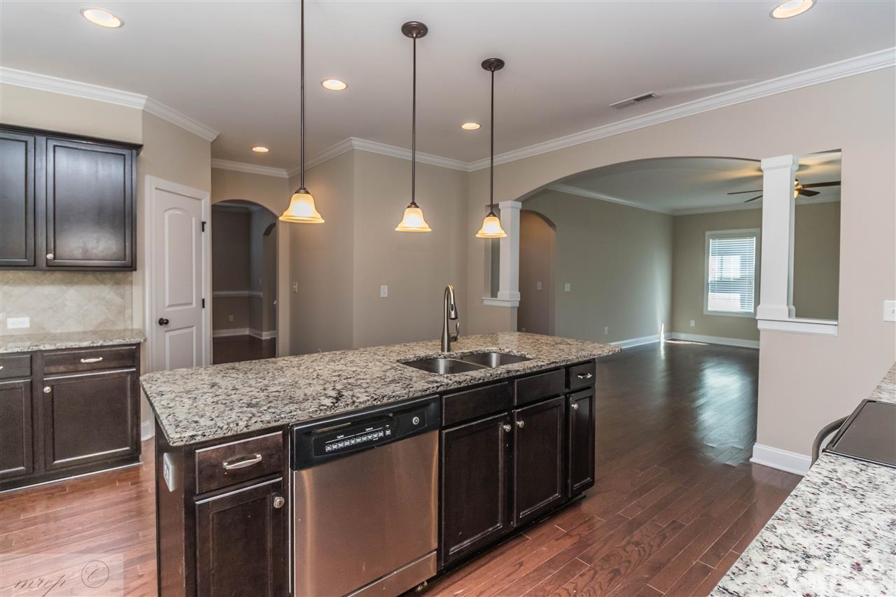 3508 Bloomfield Way Raleigh, NC 27616 - Photo 6 of 24 a kitchen with stainless steel appliances granite countertop wooden cabinets a stove a sink and dishwasher