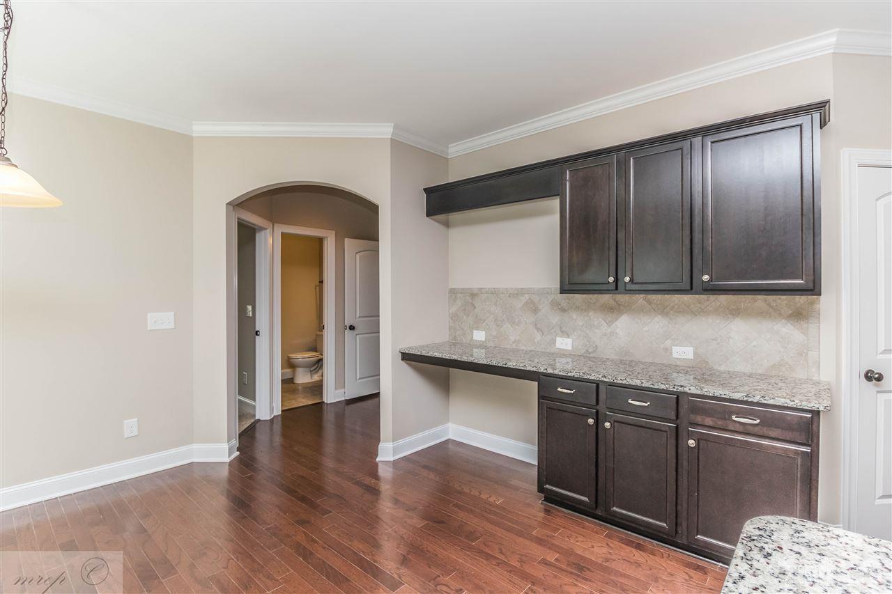 3508 Bloomfield Way Raleigh, NC 27616 - Photo 7 of 24 a kitchen with granite countertop wooden cabinets and wooden floor