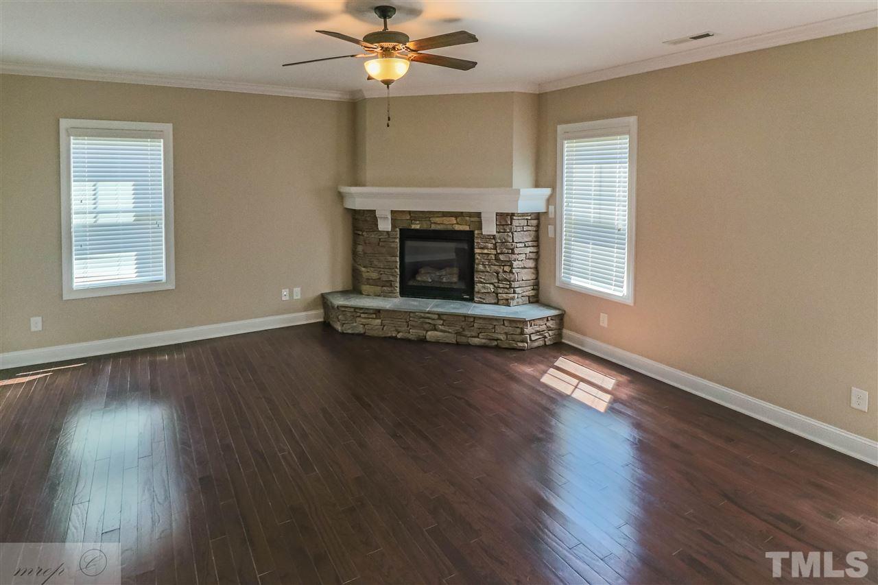 3508 Bloomfield Way Raleigh, NC 27616 - Photo 10 of 24 a living room with hard wood floors and a fireplace
