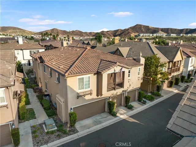 an aerial view of residential houses with city view