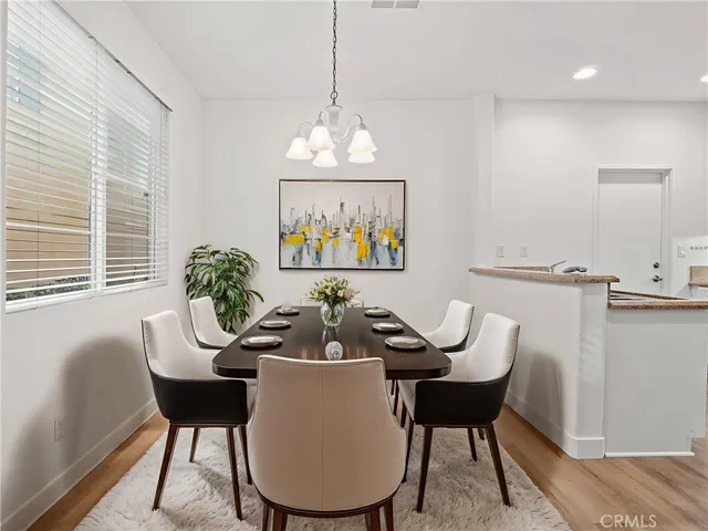 a dining room with furniture a window and a chandelier