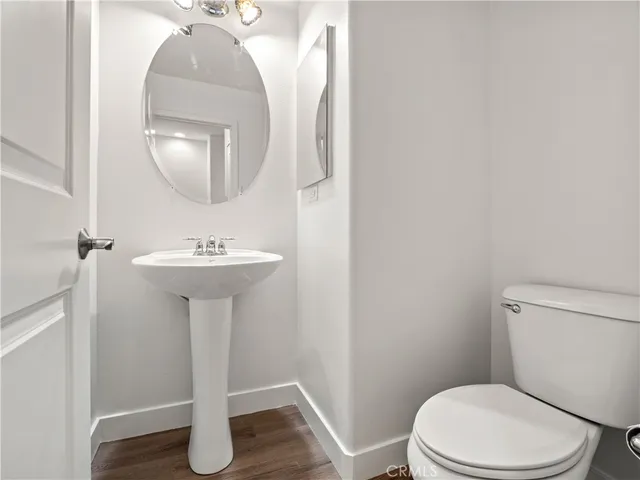 a bathroom with a sink toilet and a mirror