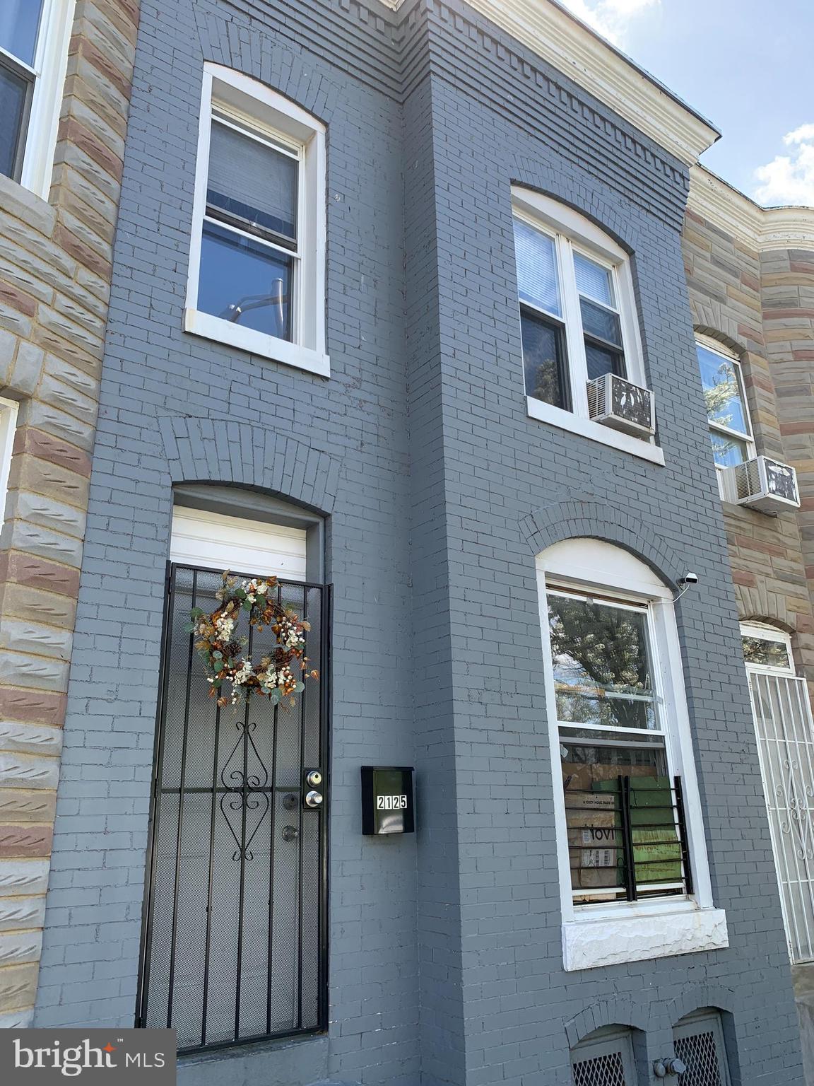 2125 East Preston Street Baltimore, MD 21213 - Photo 2 of 6 a front view of a house with a door