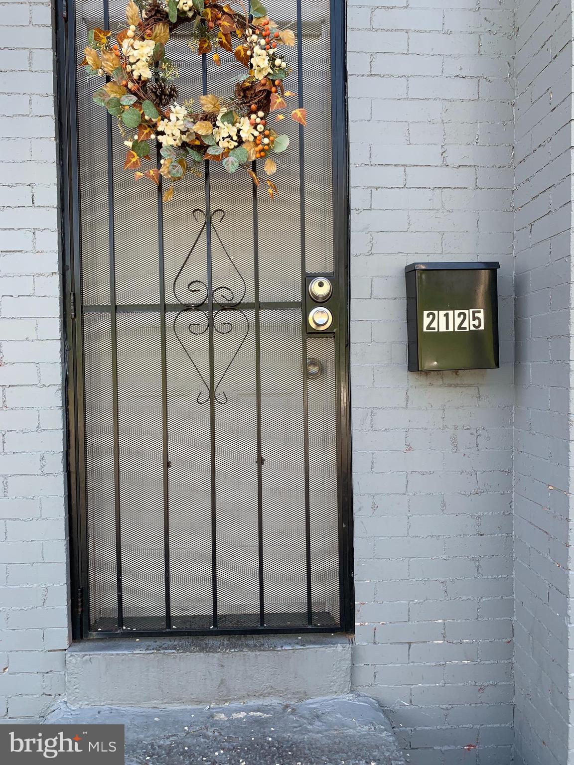 2125 East Preston Street Baltimore, MD 21213 - Photo 3 of 6 a view of a potted plant in front of a door