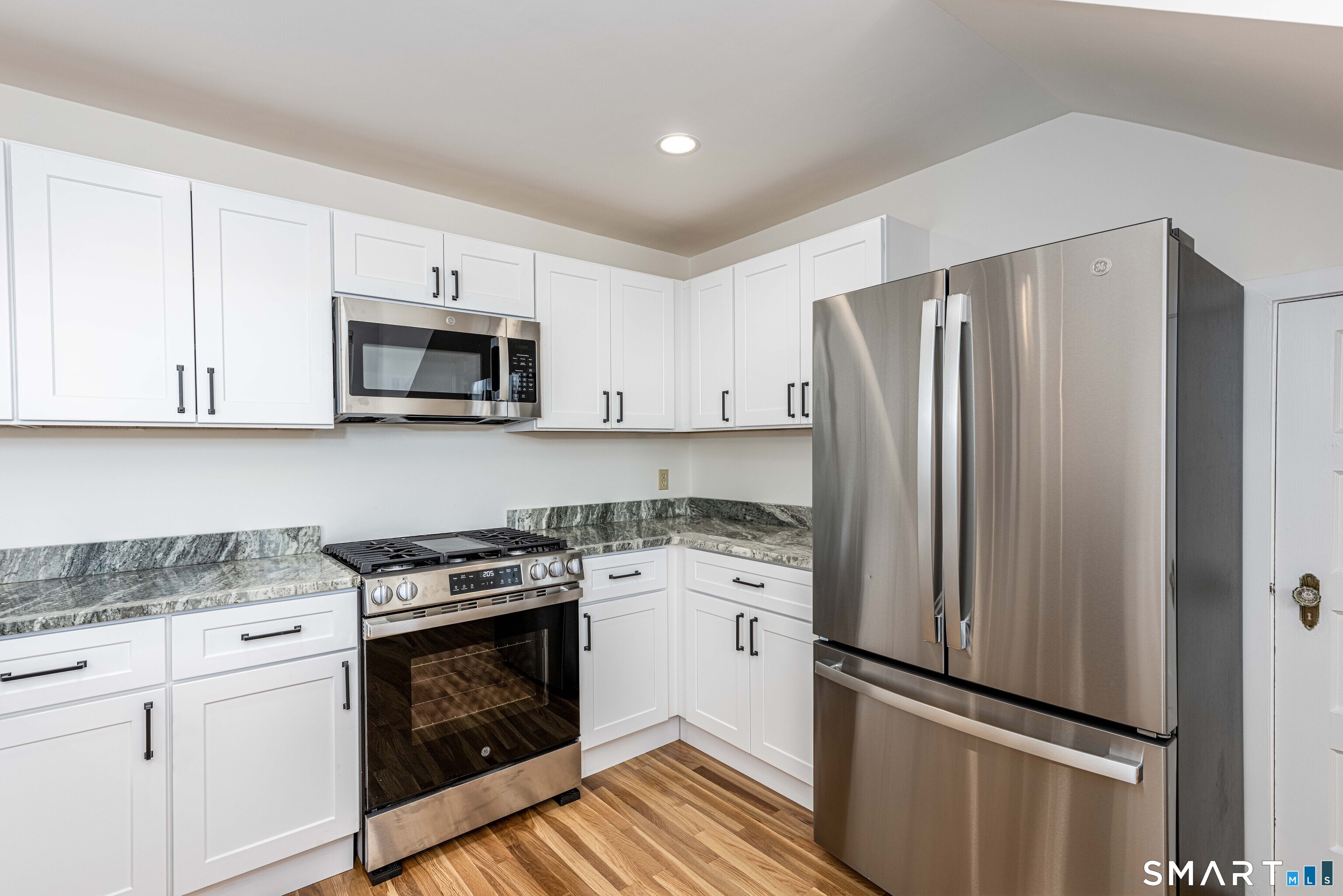 148 Everit Street, Unit F New Haven, CT 06511 - Photo 11 of 26 a kitchen with a stove microwave and refrigerator
