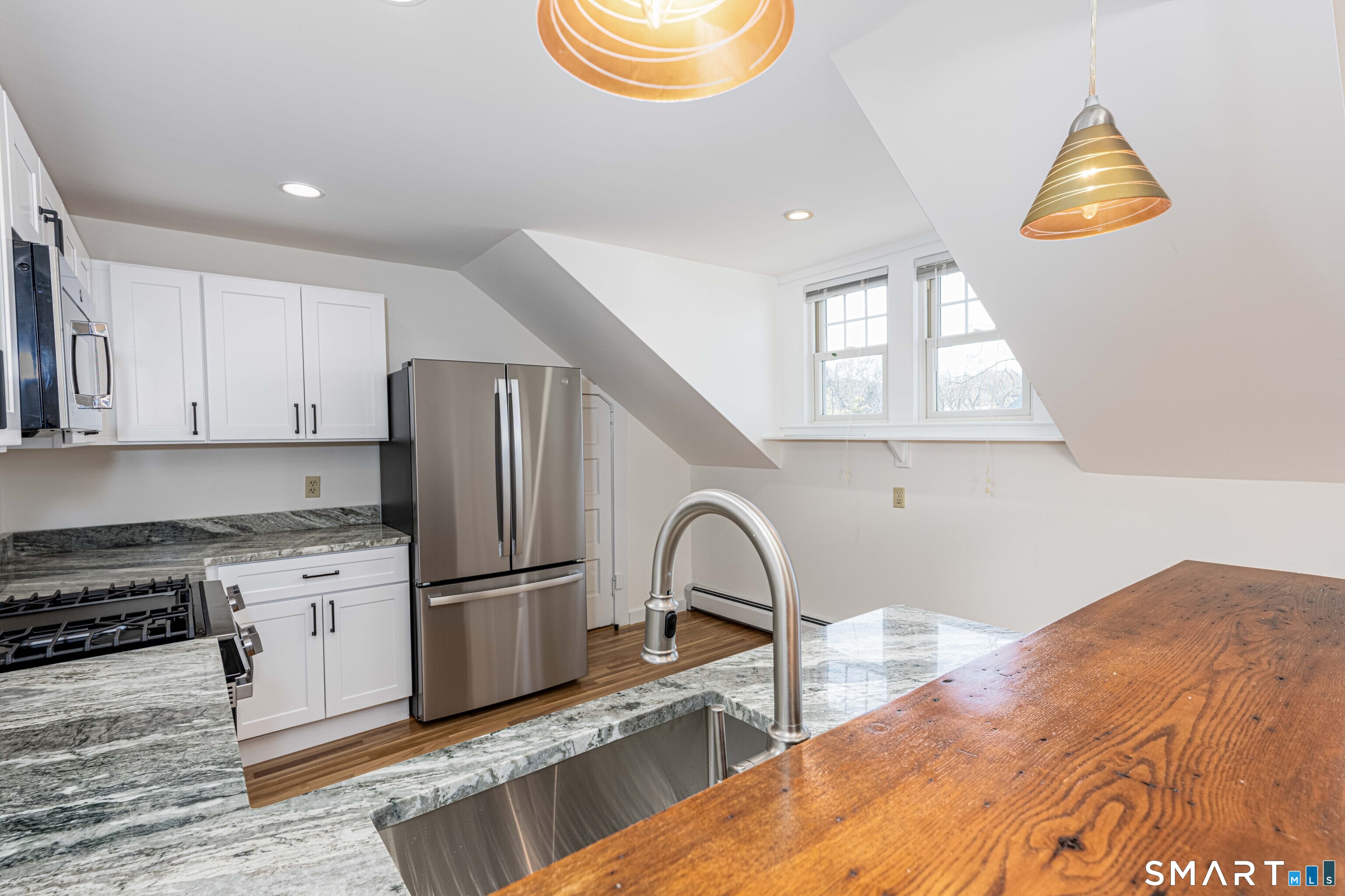 148 Everit Street, Unit F New Haven, CT 06511 - Photo 13 of 26 a kitchen with stainless steel appliances granite countertop a sink and a refrigerator