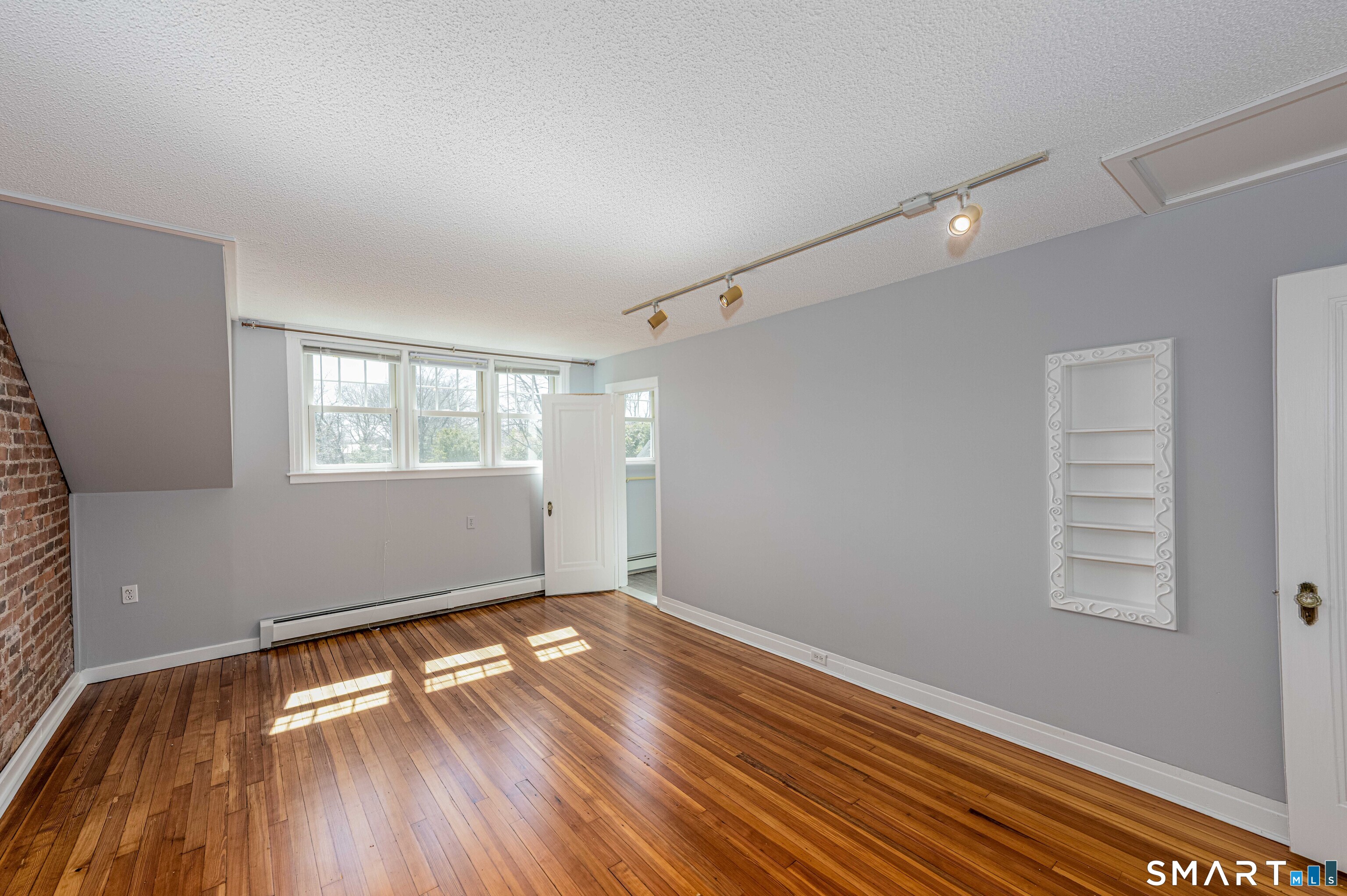 148 Everit Street, Unit F New Haven, CT 06511 - Photo 15 of 26 a view of empty room with wooden floor and fan