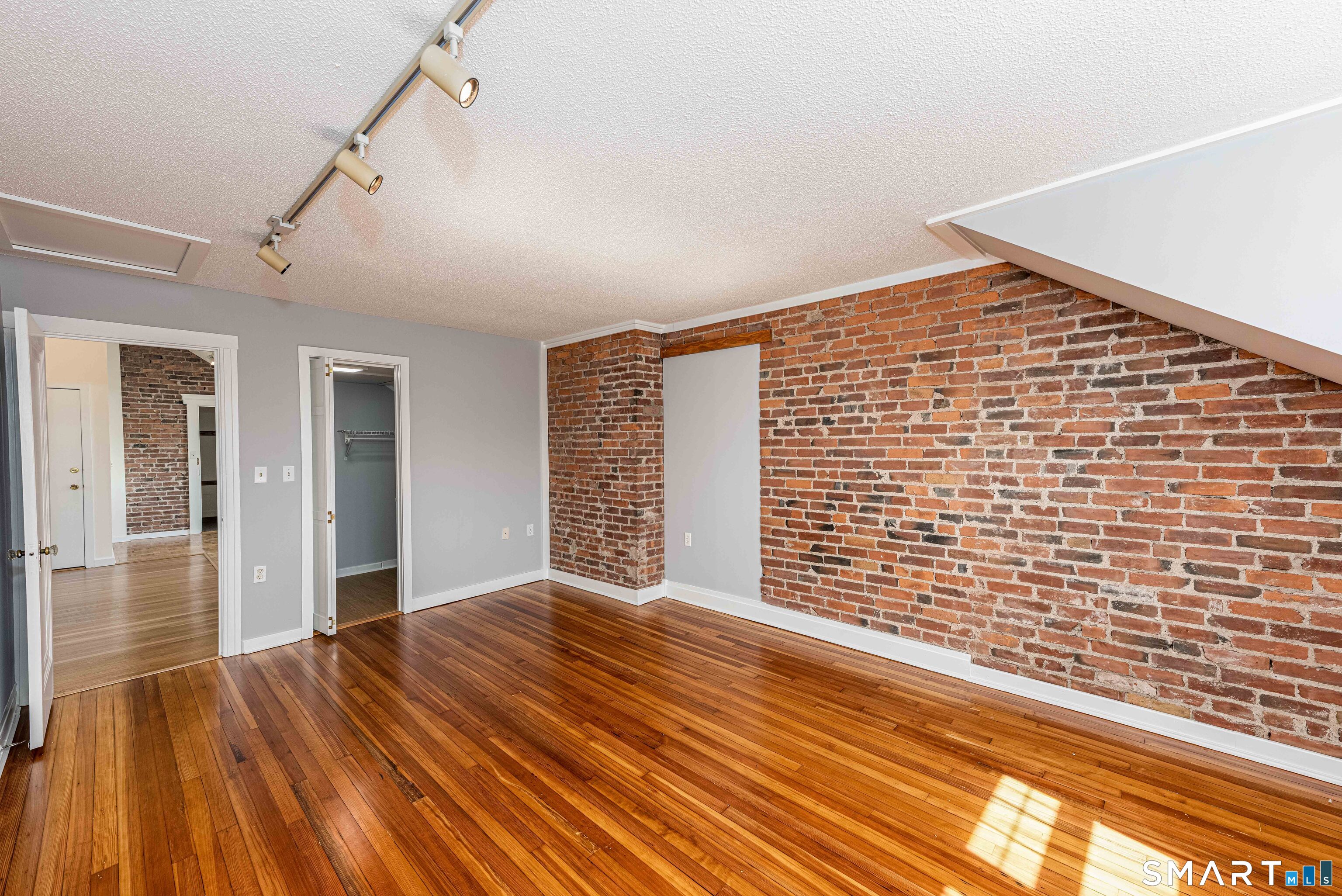 148 Everit Street, Unit F New Haven, CT 06511 - Photo 17 of 26 a view of an empty room with wooden floor and a window