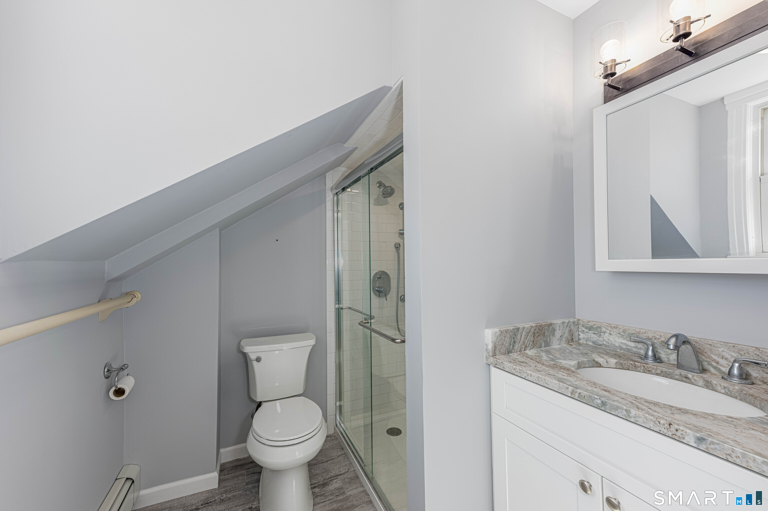 148 Everit Street, Unit F New Haven, CT 06511 - Photo 19 of 26 a bathroom with a granite countertop toilet sink and mirror