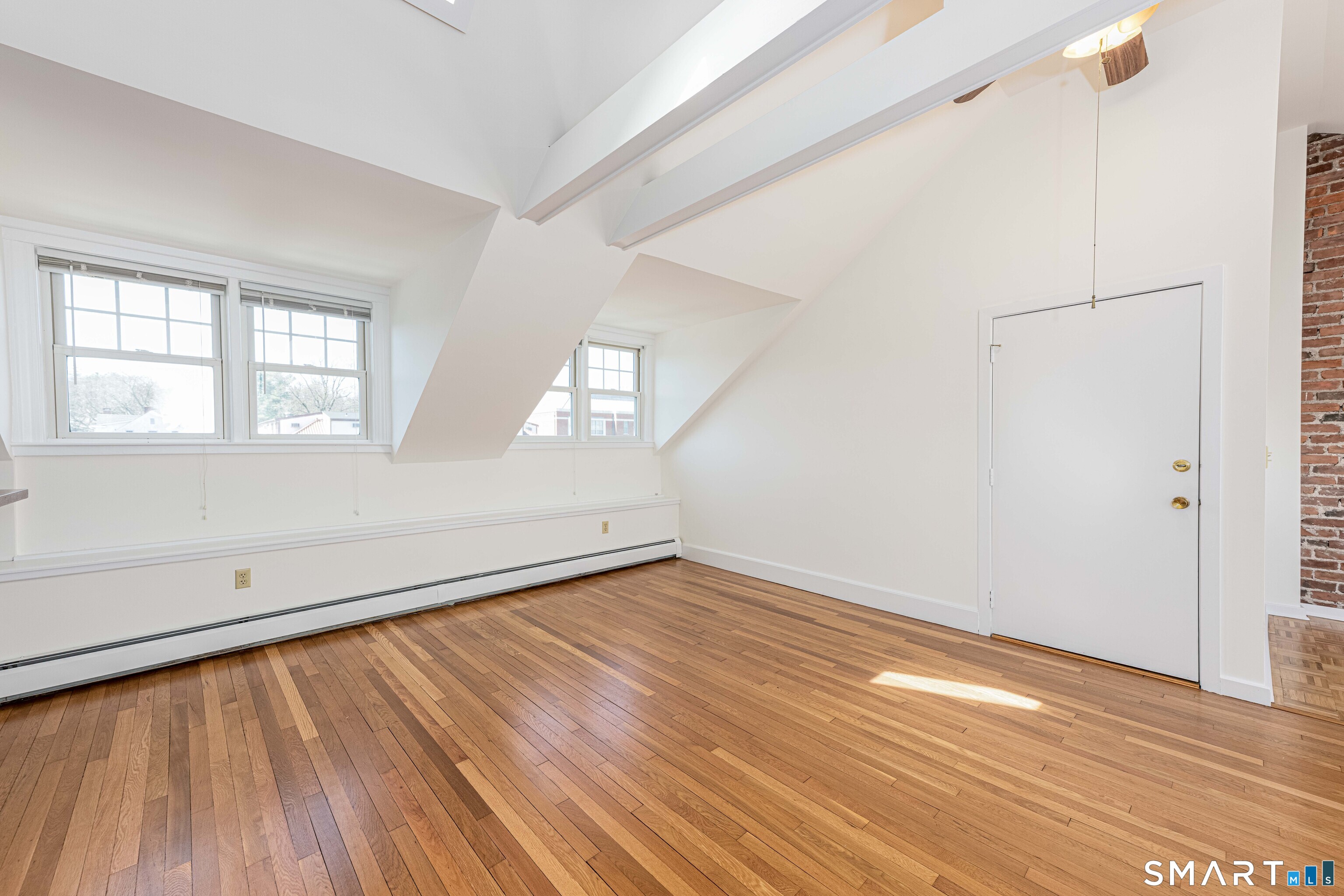 148 Everit Street, Unit F New Haven, CT 06511 - Photo 21 of 26 an empty room with wooden floor and windows