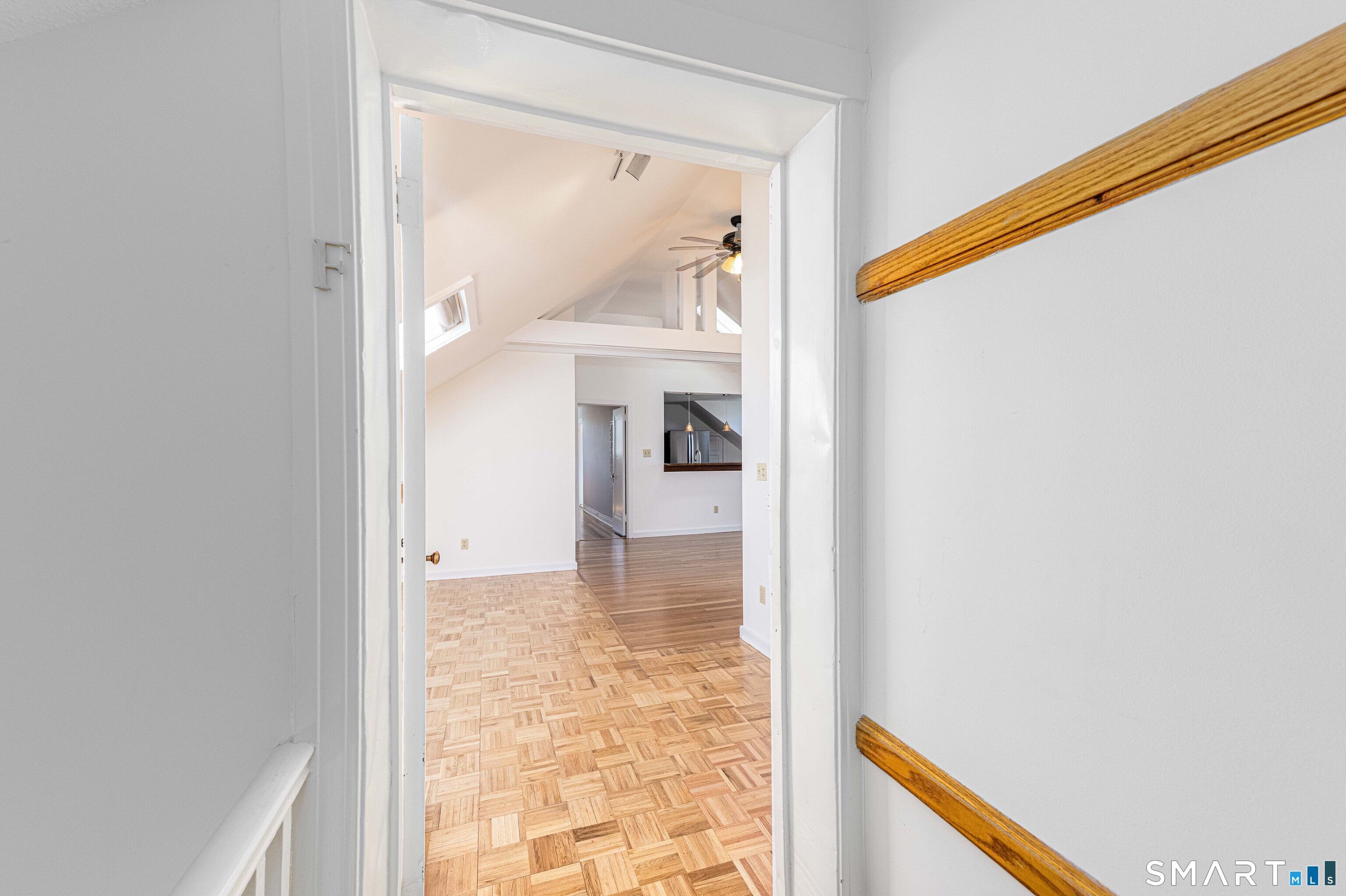 148 Everit Street, Unit F New Haven, CT 06511 - Photo 4 of 26 a view of a hallway with wooden floor and a living room