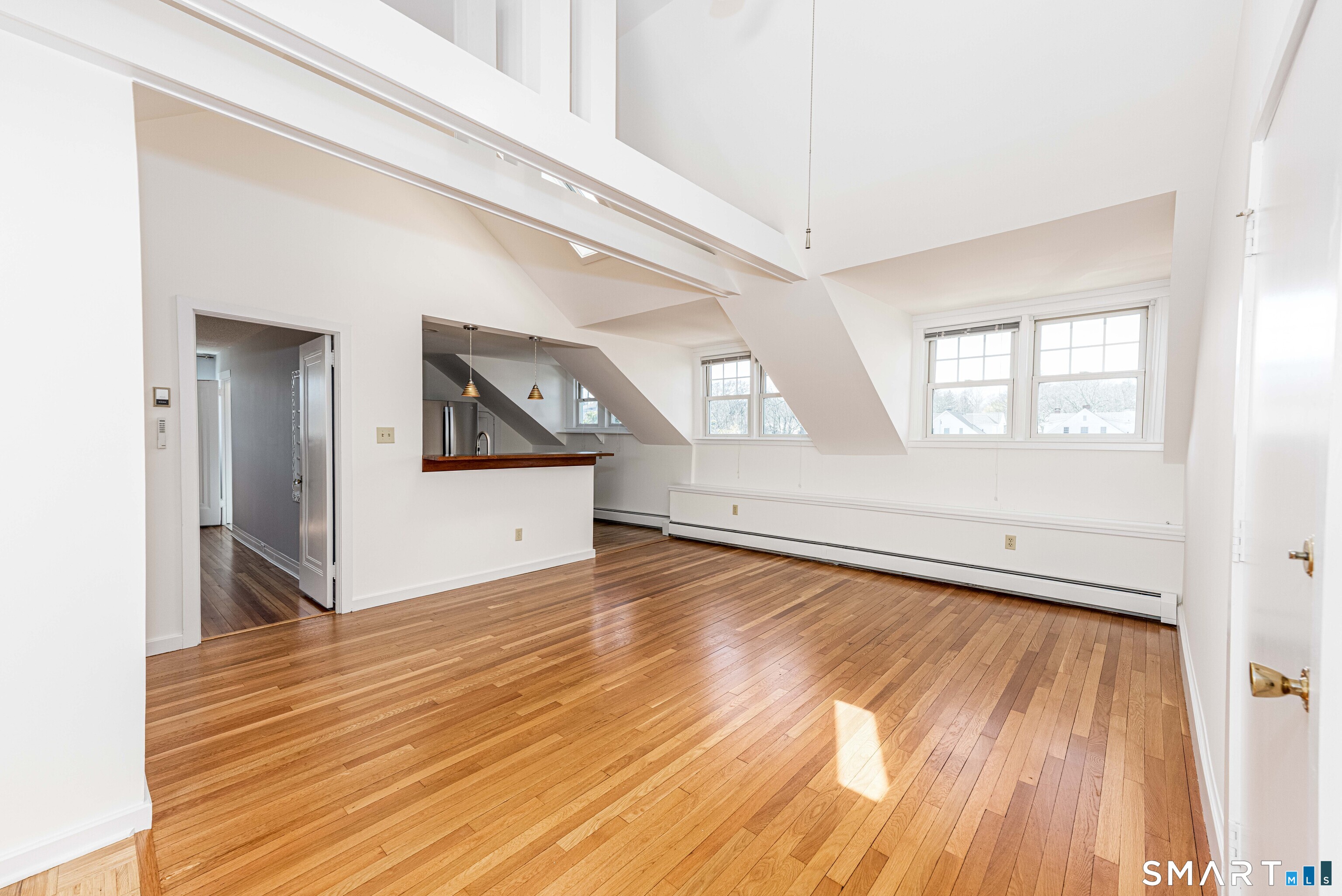 148 Everit Street, Unit F New Haven, CT 06511 - Photo 5 of 26 a view of a big room with wooden floor and windows