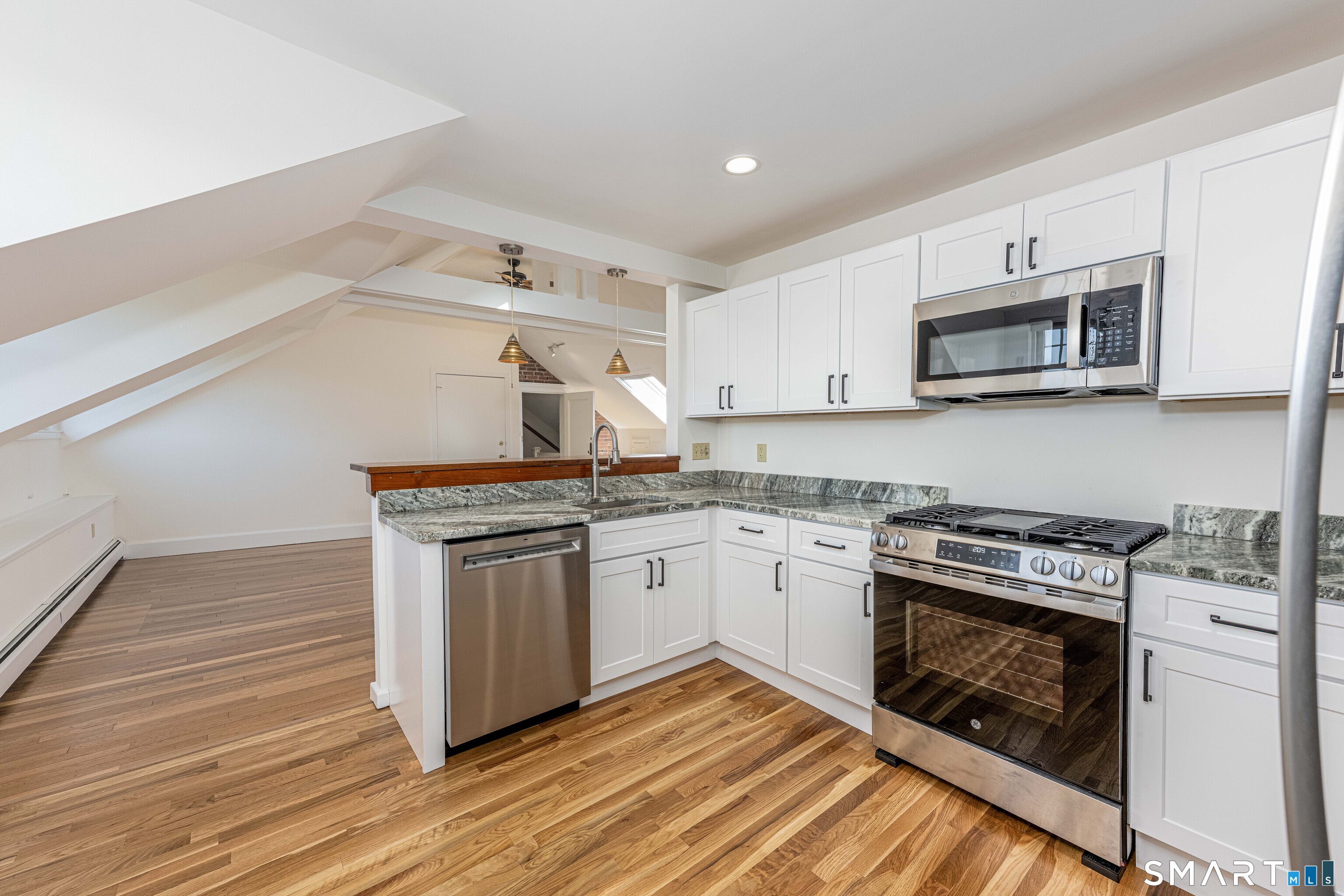 148 Everit Street, Unit F New Haven, CT 06511 - Photo 10 of 26 a kitchen with granite countertop wooden cabinets stainless steel appliances and a counter space