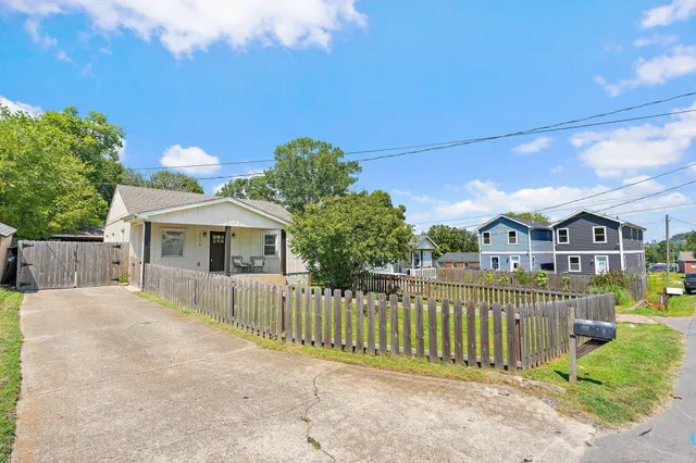 a front view of a house with wooden fence