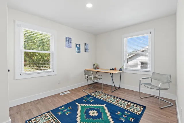 a workspace room with furniture and a window